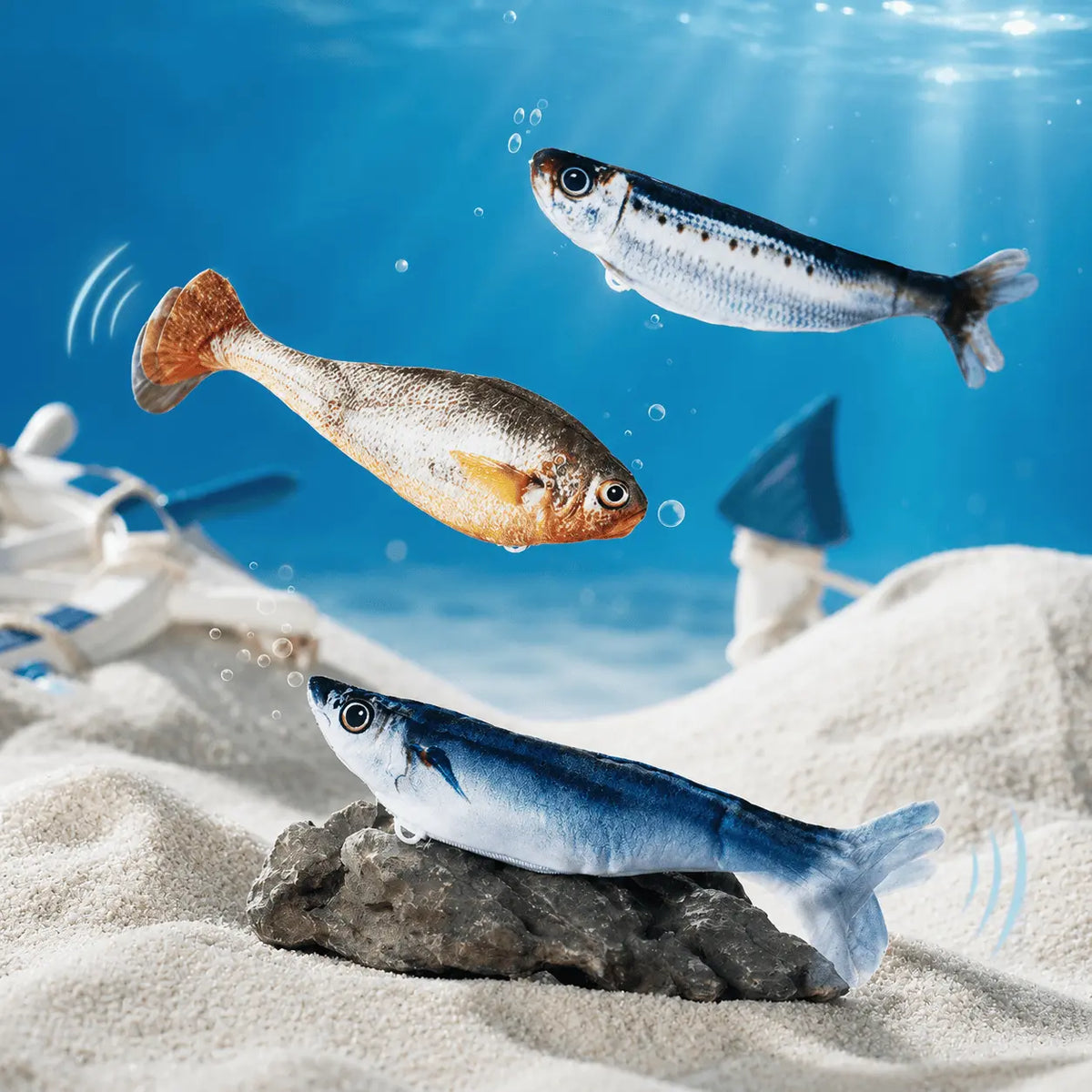 The three flopping fish cat toys shown together on a pale background
