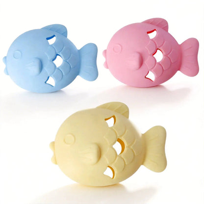 Three fish shaped silicone treat dispenser toys in blue, pink and light yellow with scale-shaped treat openings