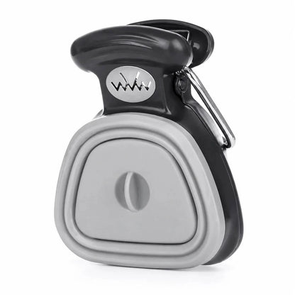 Gray foldable pooper scooper with a collapsible silicone body and a carabiner clip.