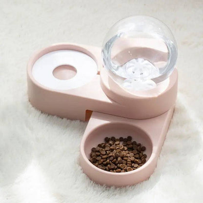 Top view of the pink gravity water dispenser showing the water bowl opening and the globe reservoir