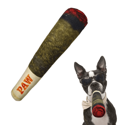 Green Noblias plush cigar dog toy shown beside a boston terrier carrying it in its mouth.