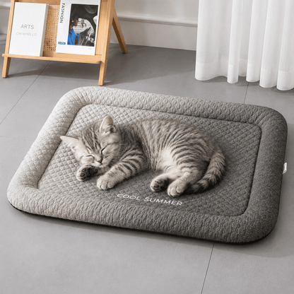 Tabby cat stretched out on the gradient black ice silk cooling mat with COOL SUMMER embroidered along the front.