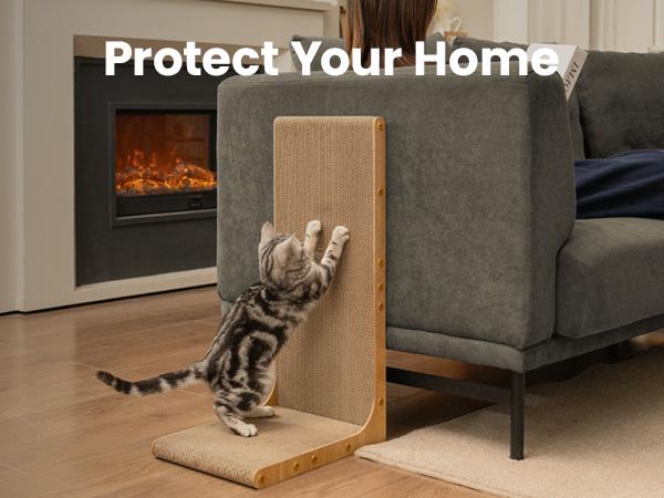 Tabby cat scratching the Noblias L shaped sisal cat scratcher standing against the arm of a gray sofa.