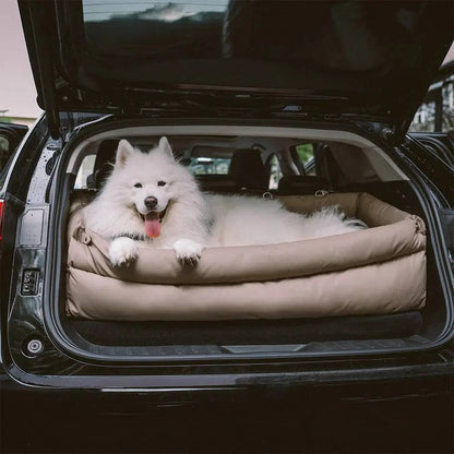 A samoyed stretched out in the Noblias large dog car seat bed sitting flat in an open SUV boot.