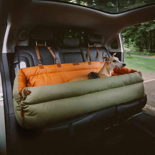 The orange and green Noblias large dog car seat bed fitted across the rear bench of a car.