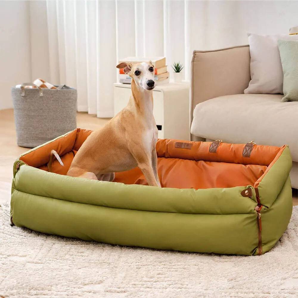 A whippet lying in the Noblias large dog car seat bed used as a bed in a living room.