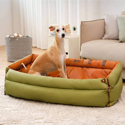 A whippet lying in the Noblias large dog car seat bed used as a bed in a living room.