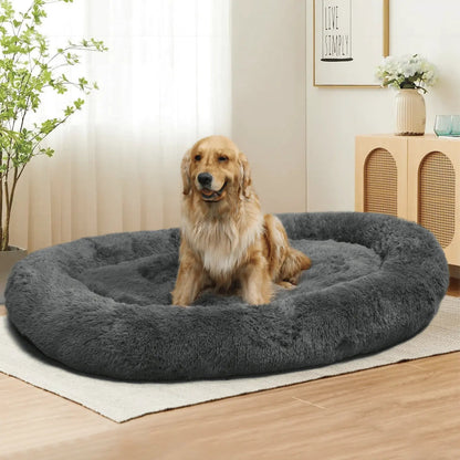 Dark gray Noblias large plush dog bed with a dog sitting in it.