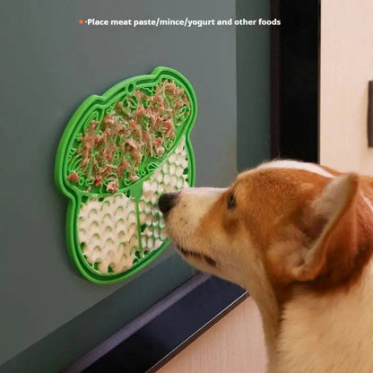 Green lick mat suctioned to a wall with meat paste spread on it and a corgi licking, captioned place meat paste, mince, yogurt and other foods.