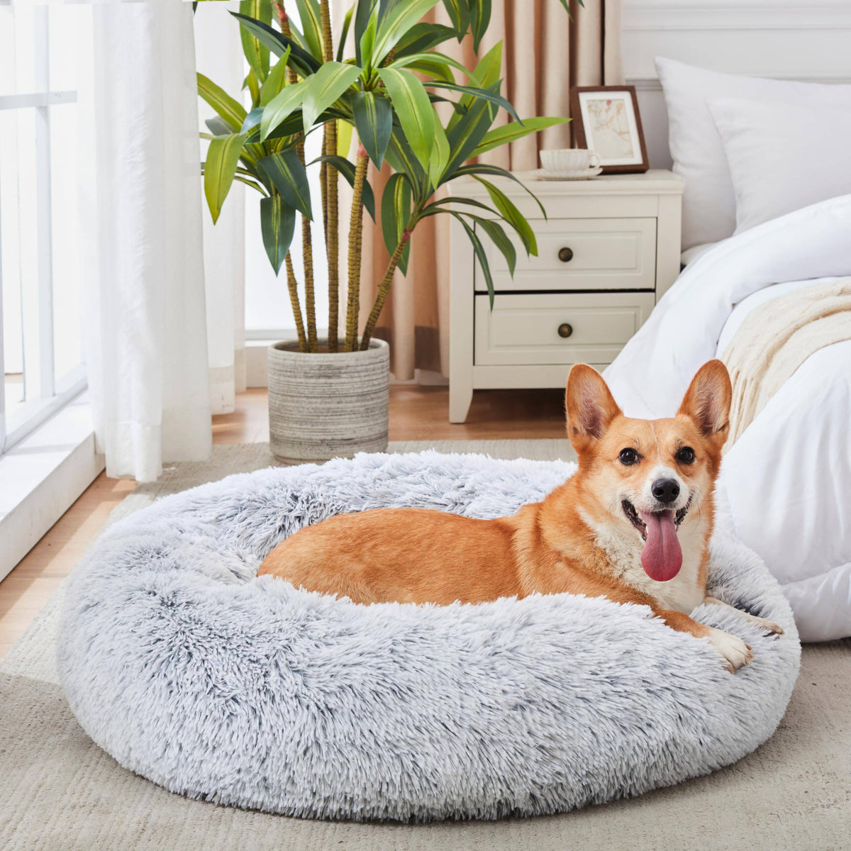 Light gray Noblias Cloud Calming Donut Bed for small dogs and cats, soft and cozy pet resting spot in a rounded shape.