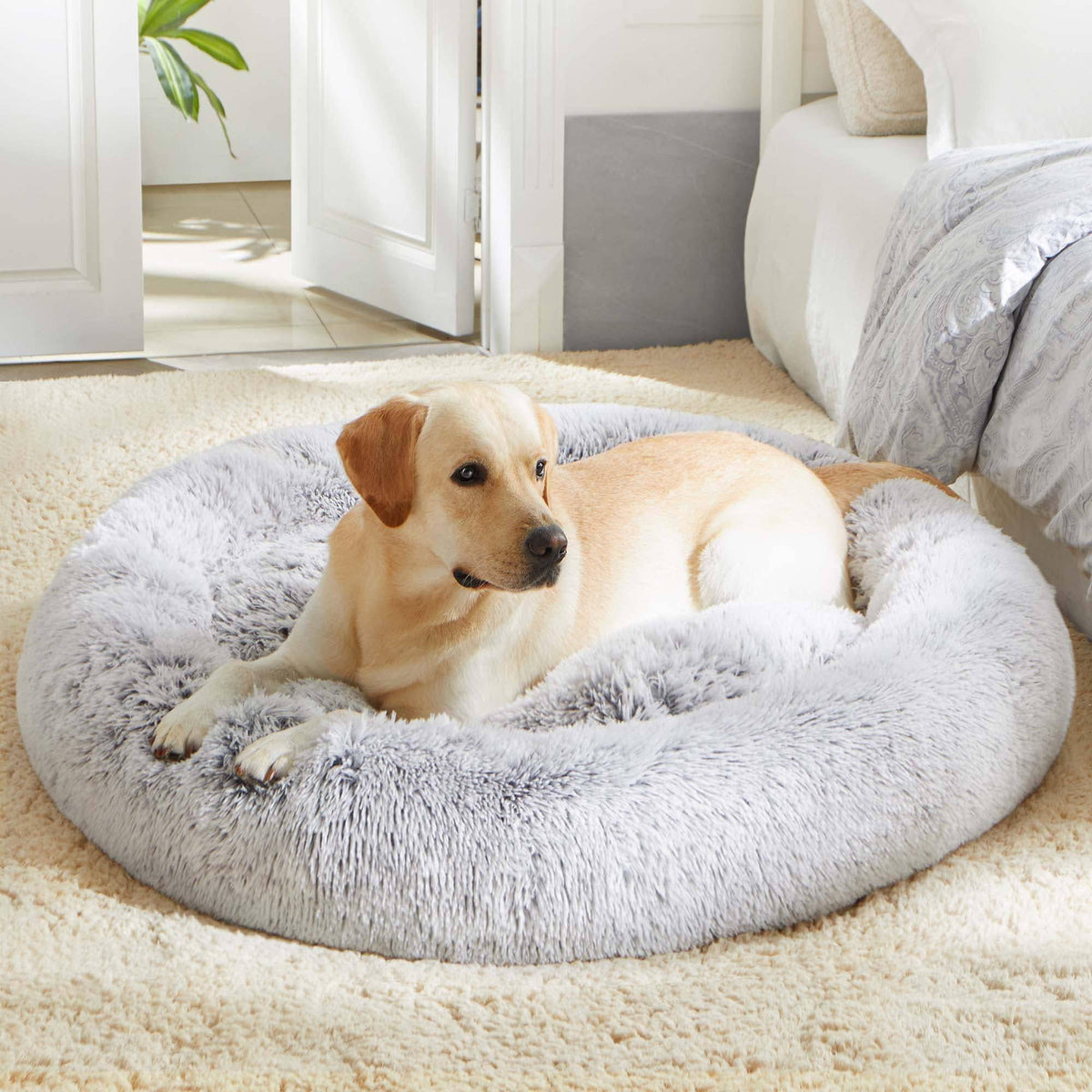 Light gray Noblias Cloud Calming Donut Bed for dogs and cats, cozy round shape with soft plush fabric for comfort.