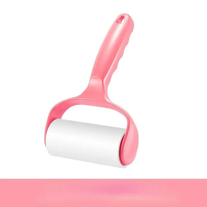Pink lint roller for pet hair on a white background.