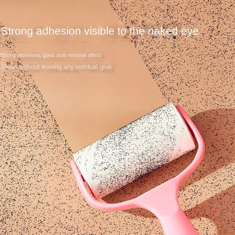 Pink lint roller for pet hair picking crumbs and dust off a board, captioned strong adhesion visible to the naked eye.