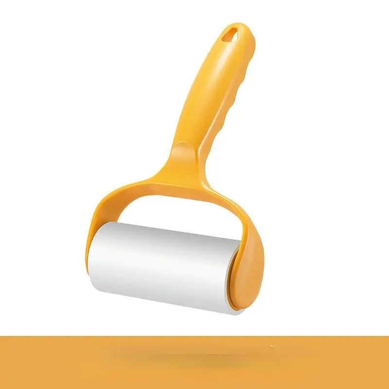 Yellow lint roller for pet hair on a white background.