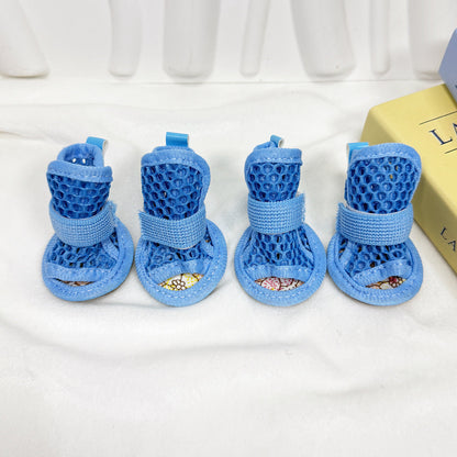 Set of four blue Noblias mesh dog sandals showing the open toe and the patterned non-slip sole.