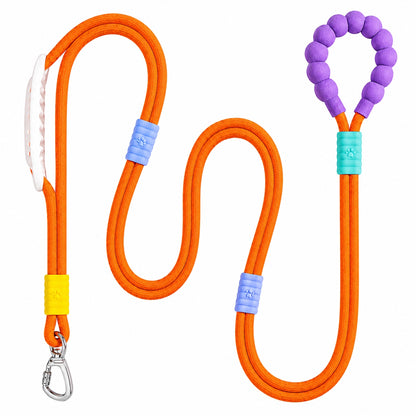 The orange Noblias hands free dog leash laid out, showing the silicone beaded loop handle and the metal swivel clip.