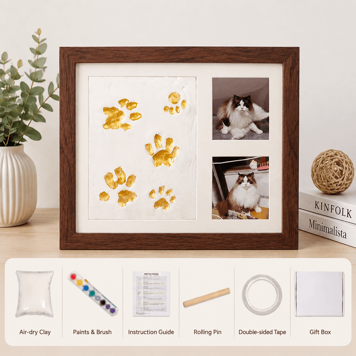 Walnut paw print keepsake frame kit with gold paw prints and two cat photos, above the air dry clay, paints and brush, instruction guide, rolling pin, double sided tape and gift box.