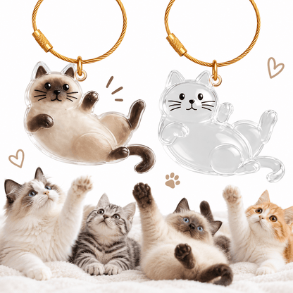 Reclining cat pet fur keepsake keychain shown filled with Siamese fur next to an empty one.