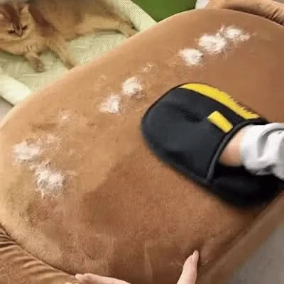 Noblias pet hair remover glove wiping pet hair off a brown suede sofa cushion.