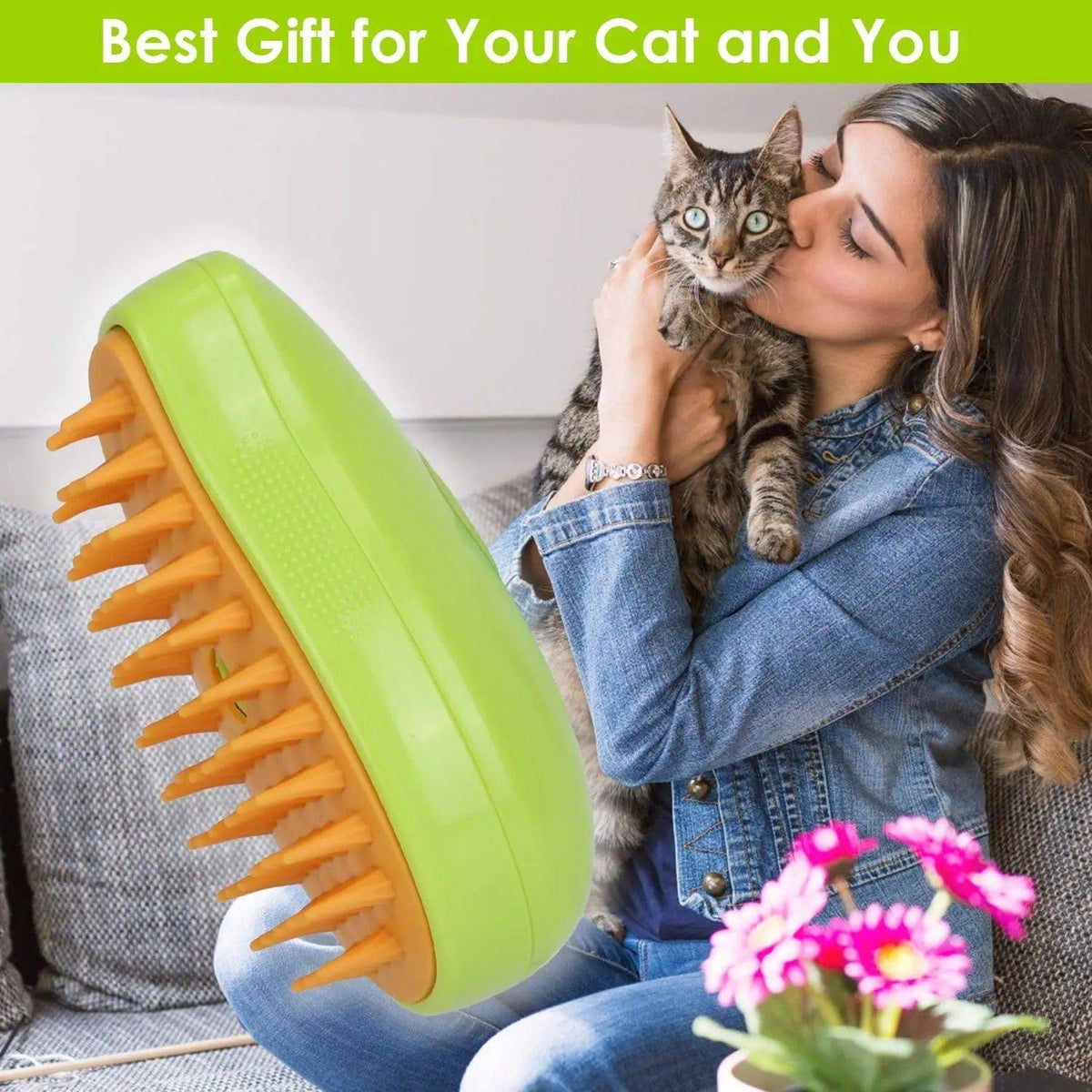 Green pet steam brush in front of a woman kissing her tabby cat on a sofa.