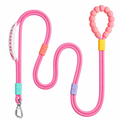 The pink Noblias hands free dog leash laid out, showing the silicone beaded loop handle and the metal swivel clip.