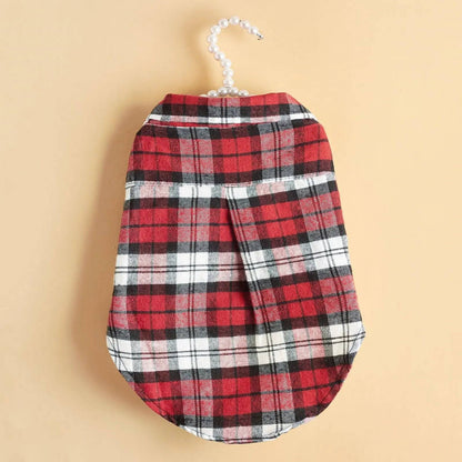 Back of the red plaid flannel dog shirt on a hanger against a cream background.