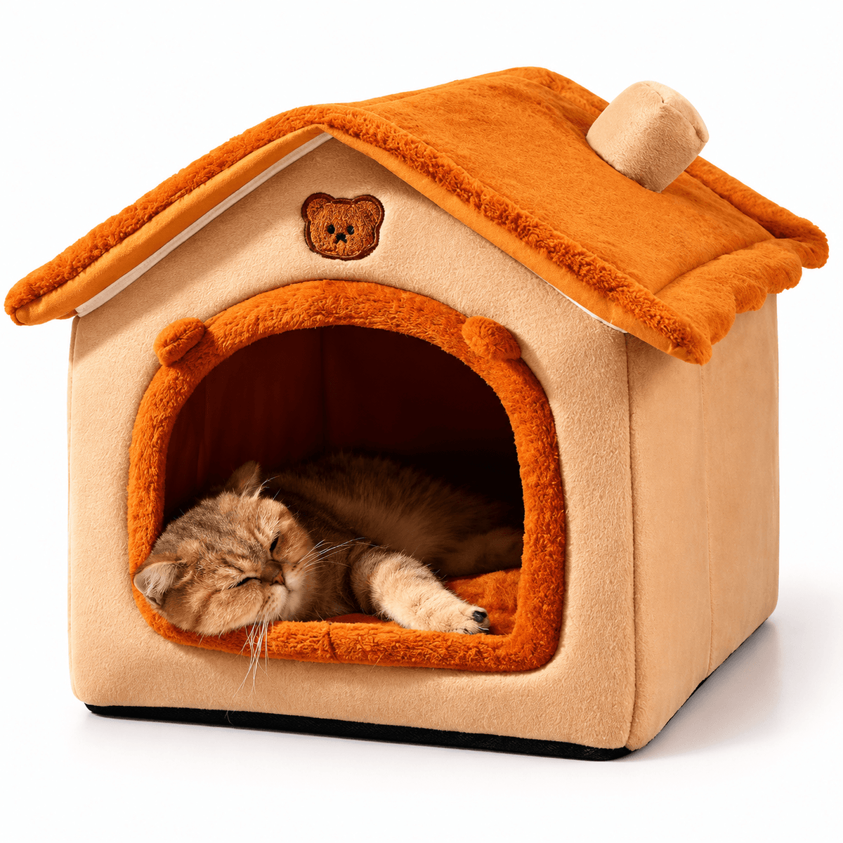 Orange and beige washable plush cat house bed with a bear patch on the roof and a tabby cat sleeping inside.