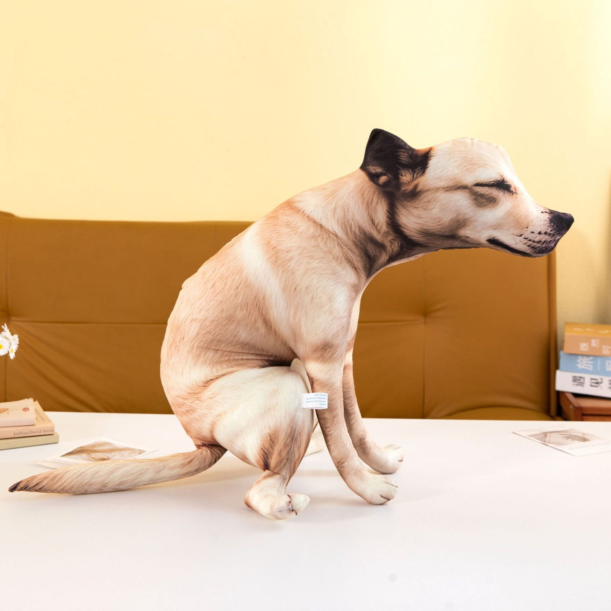 Side view of the funny pooping dog plush toy in its squatting pose with a realistic dog print.