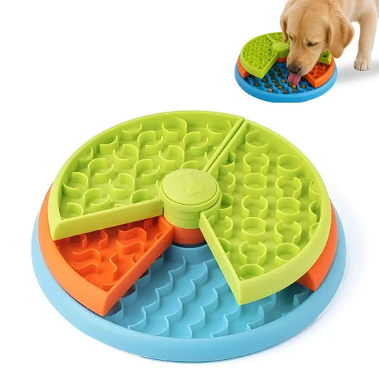 Three layer puzzle slow feeder dog bowl in green, orange and blue with a Labrador puppy eating from it.