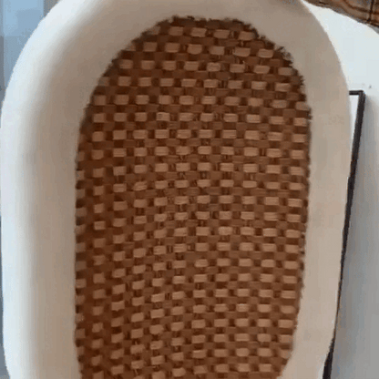 Animation of a white cat kneading the woven rattan center of the rattan cat scratcher bed.