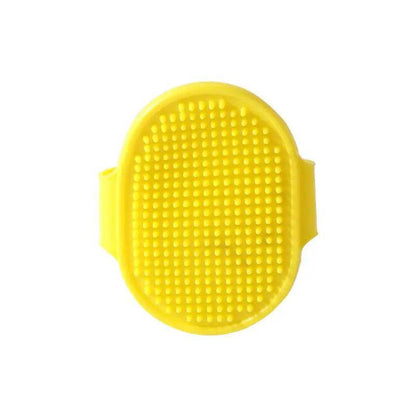 Yellow oval rubber pet bath brush with its molded hand strap, shown face on against a white background.