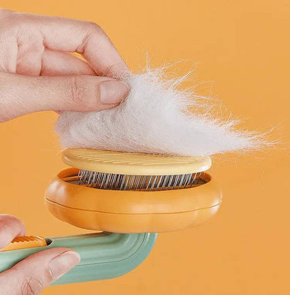 Hand peeling a sheet of fur off the retracted pin plate of the self cleaning cat slicker brush.