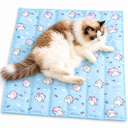 Ragdoll cat lying on the blue kitty print self cooling gel mat on a white floor.