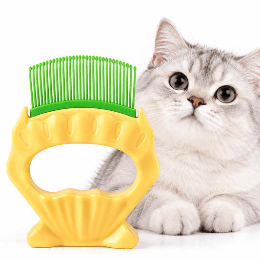 Shell shaped cat deshedding comb with green teeth and a yellow handle next to a silver tabby cat.