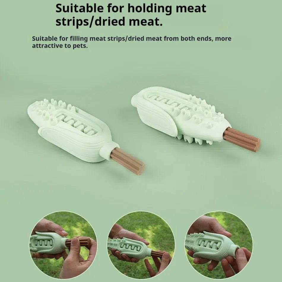 Green silicone corn dog chew toys with jerky strips threaded through the channel from both ends.