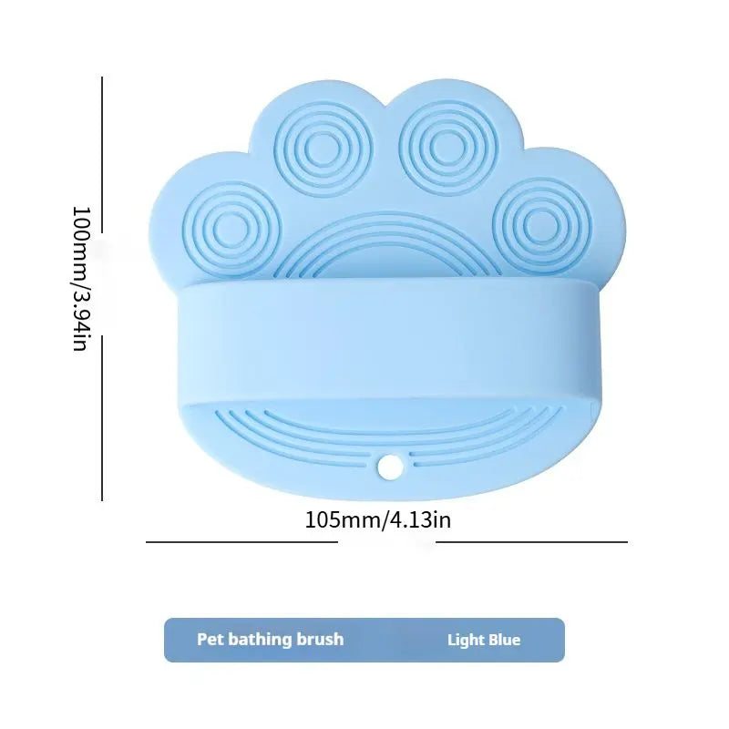 Light blue silicone dog bath brush with its 105 mm width and 100 mm height marked.