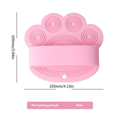 Pink silicone dog bath brush with its 105 mm width and 100 mm height marked.
