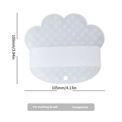 Transparent silicone dog bath brush with its 105 mm width and 100 mm height marked.