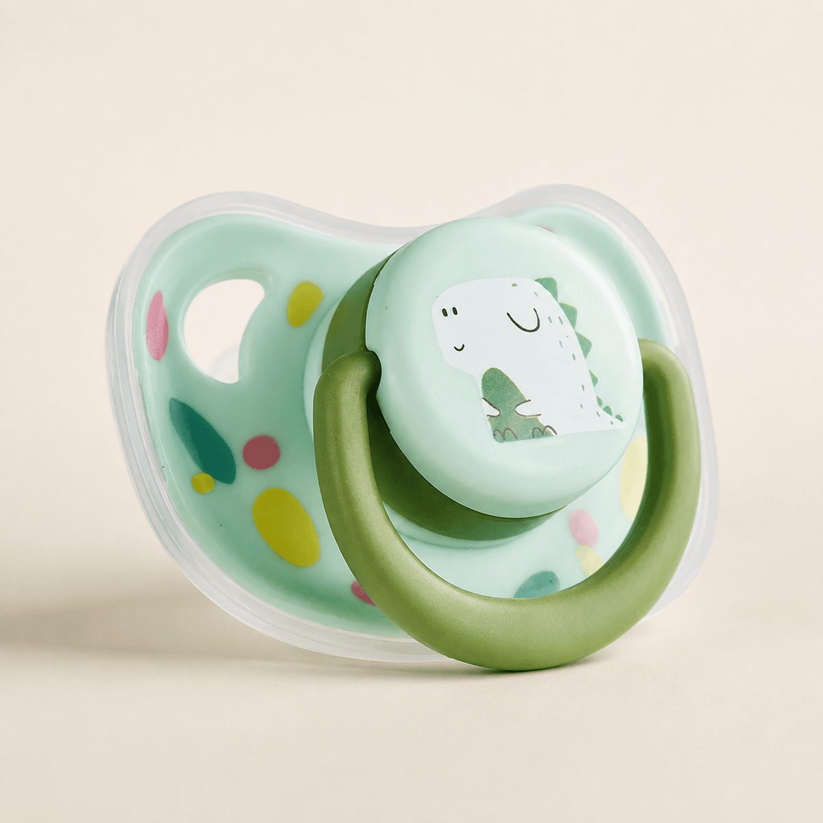 Green dinosaur silicone puppy chew toy with a mint shield and a green movable ring