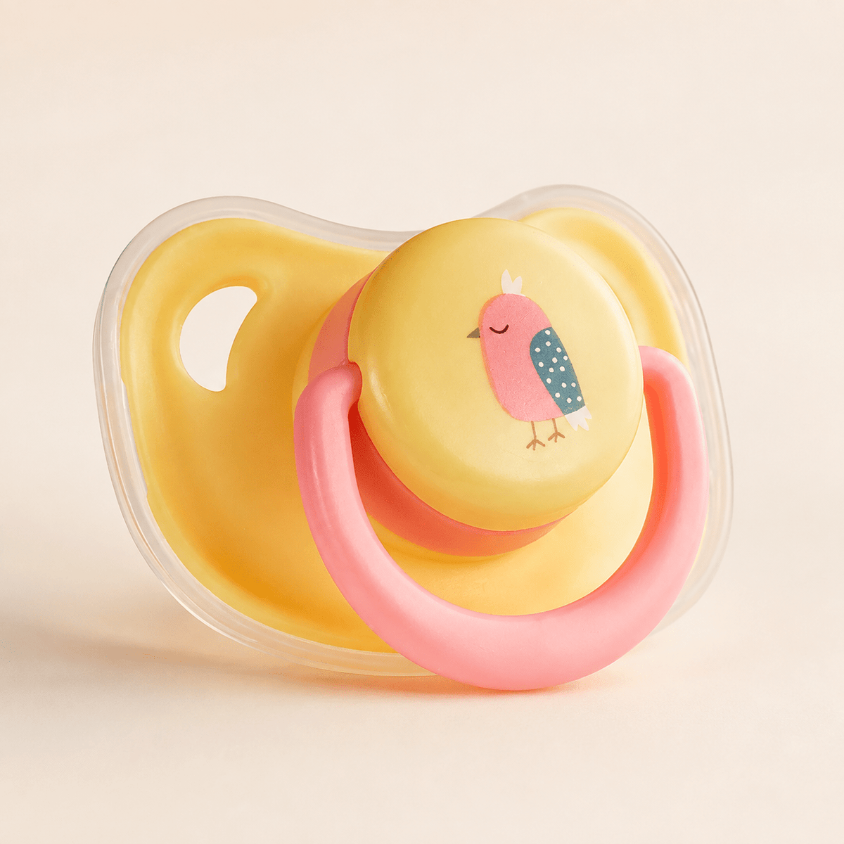 Pink bird silicone puppy chew toy with a yellow shield and a pink movable ring