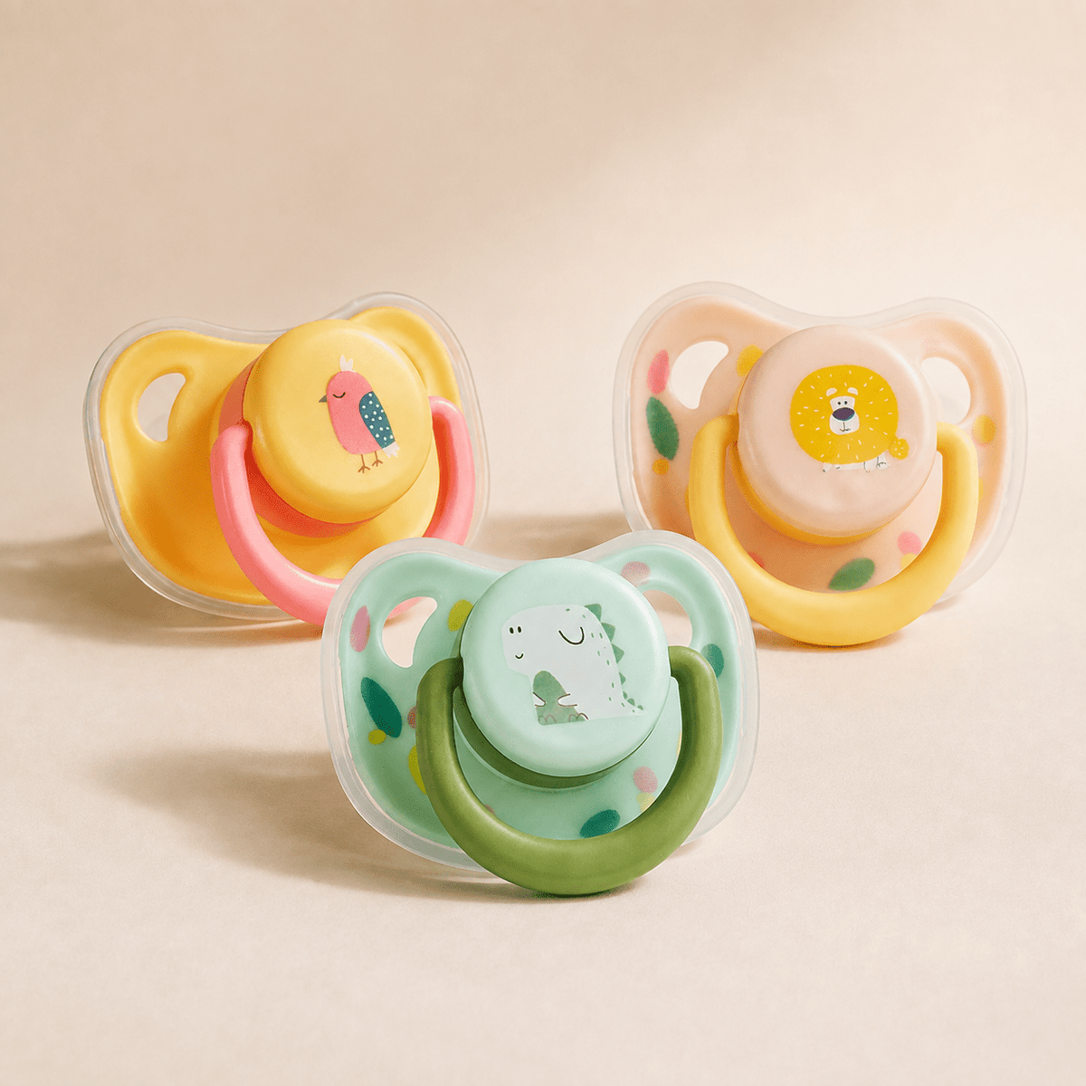 Silicone puppy chew toy in pink bird, green dinosaur and yellow lion colorways