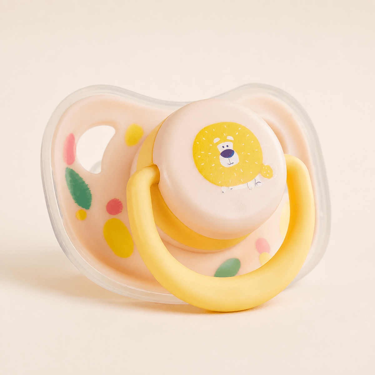 Yellow lion silicone puppy chew toy with a peach shield and a yellow movable ring