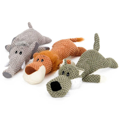 Gray elephant, orange lion and green wolf squeaky plush animal dog toys laid flat on a white background.