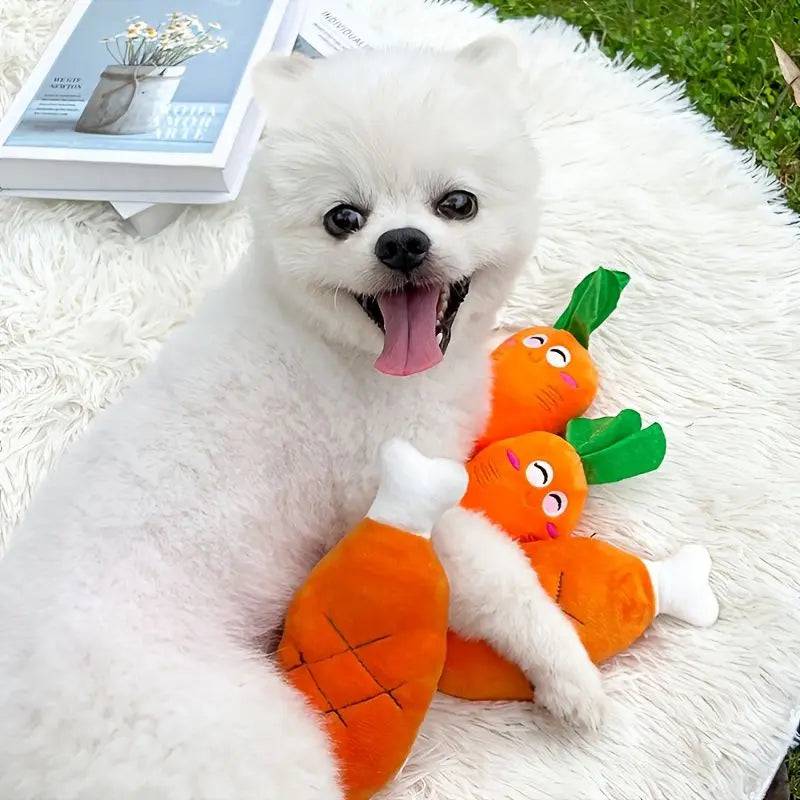 White Pomeranian hugging the plush chicken leg squeaky toy beside two plush carrot toys with embroidered faces.
