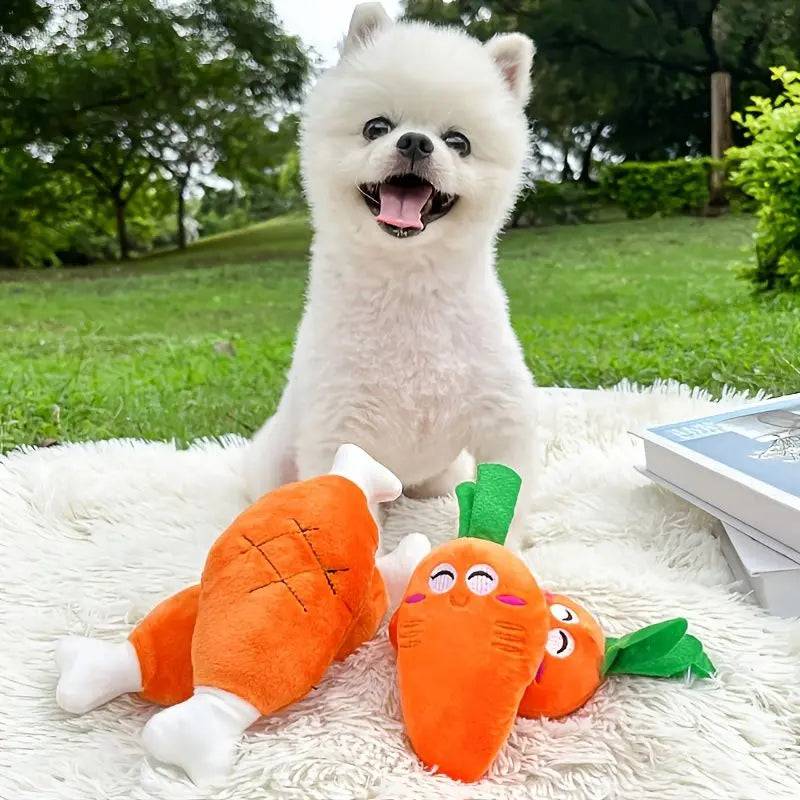 White Pomeranian sitting on a picnic blanket with the plush chicken leg and two plush carrot squeaky toys.