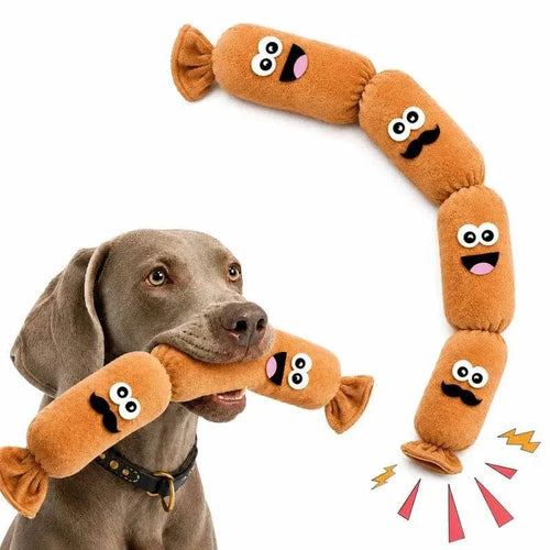 Weimaraner carrying the four link squeaky sausage dog toy, each segment printed with a cartoon face.