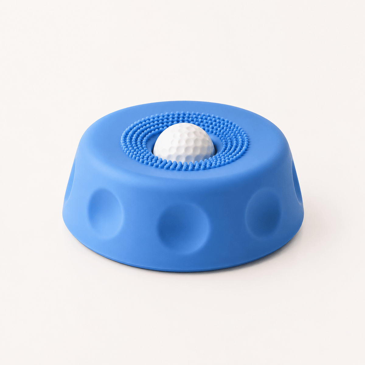 Blue suction dog lick bowl with a white rolling ball on a cream background.