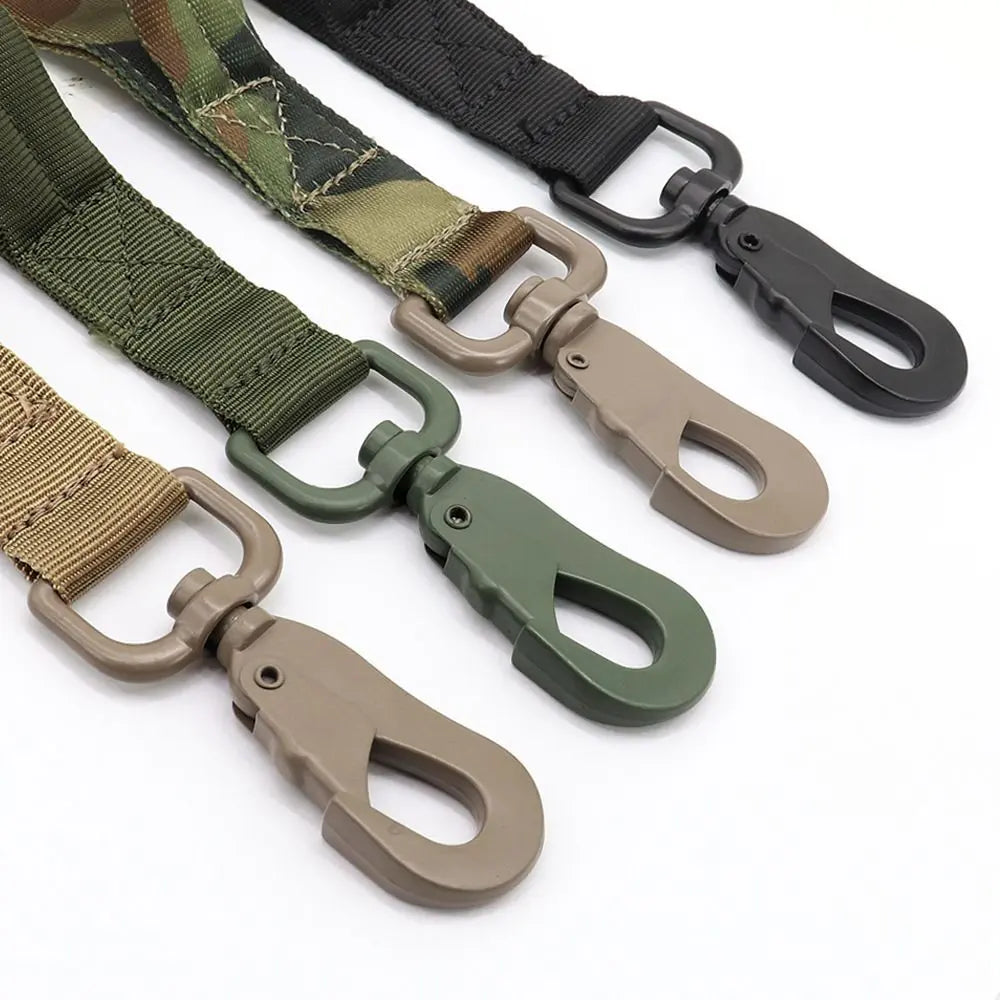 Close-up of the metal snap hooks of the tactical bungee dog leash in camo, green, tan and black.
