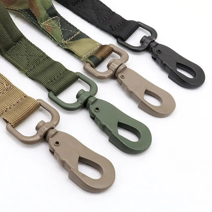 Close-up of the metal snap hooks of the tactical bungee dog leash in camo, green, tan and black.