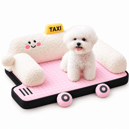 White bichon sitting on the pink quilted cushion of the taxi car shaped pet bed with cream plush bolsters.